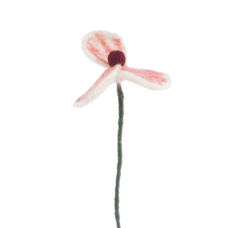 Artificial flower with red center and white petals on a white background