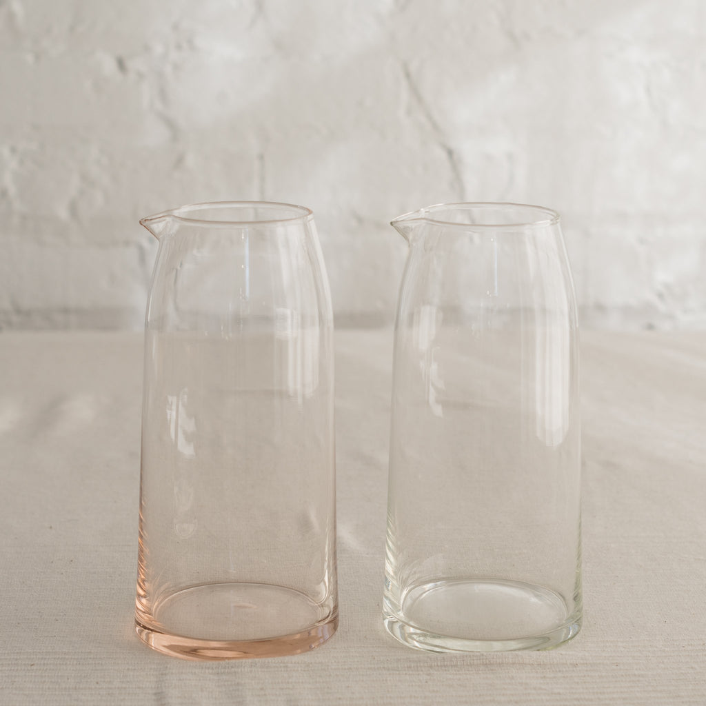 Mid-century modern shape glass pitcher in peach and clear.