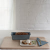 blue small porcelain baking dish with a loaf of bread made in it.